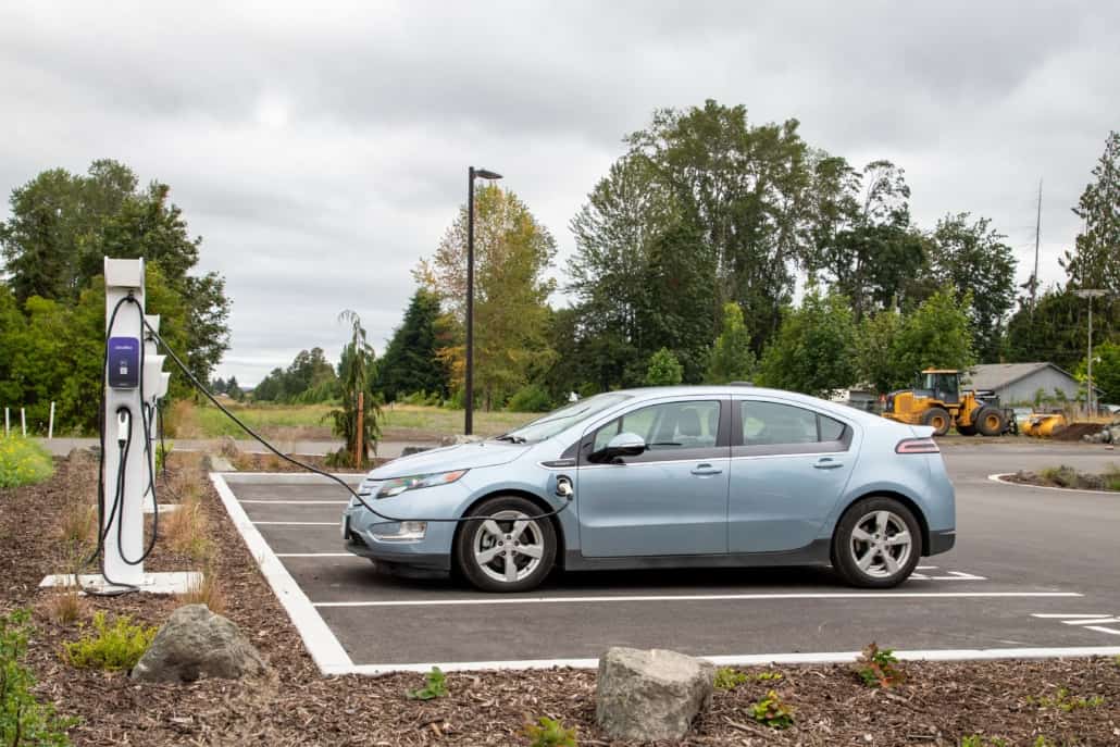 electric car parked in a parking lot charging
